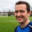 Vaj Inusah, Sunday league captain, smiling beside a football pitch in Norwich