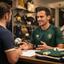 Elmubark Arentoft discussing a team football kit order at the shop counter